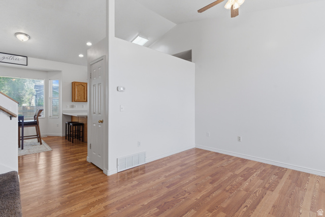 134 West 475 South Ogden, UT 84404 - Photo 4 of 27 Unfurnished room with vaulted ceiling, light wood-type flooring, and ceiling fan