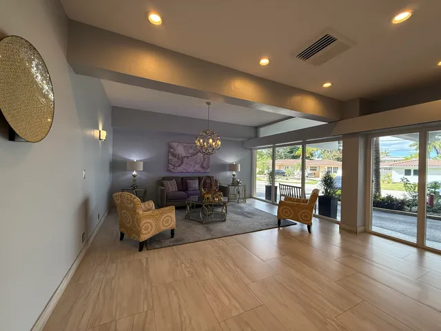 a living room with furniture a fireplace and wooden floor