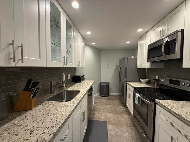 a kitchen with a sink stove and microwave
