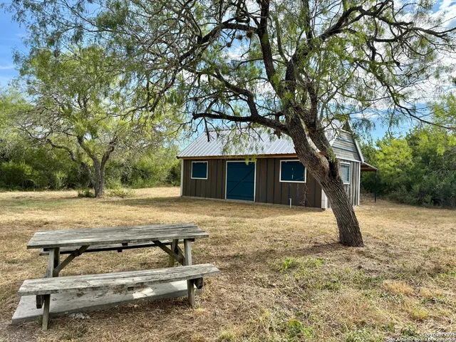 a view of a house with backyard space and sitting area