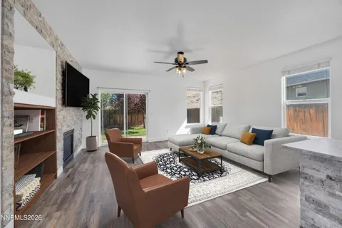 a living room with furniture a fireplace and a flat screen tv