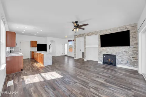 a living room with furniture a flat screen tv and a fireplace
