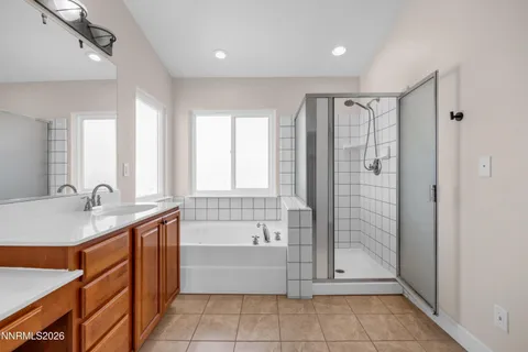 a bathroom with a tub sink and mirror