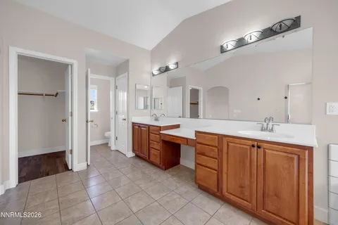 a spacious bathroom with a granite countertop sink mirror and a