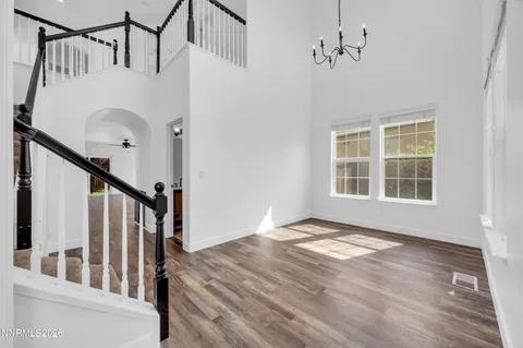 a view of an entryway with wooden floor and door