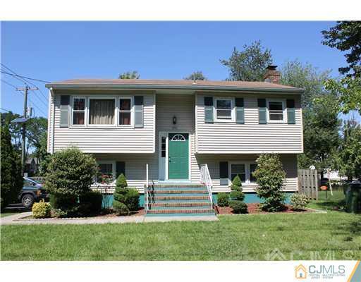 896 Inman Avenue Edison, NJ 08820 - Photo 1 of 14 a front view of a house with a garden and plants