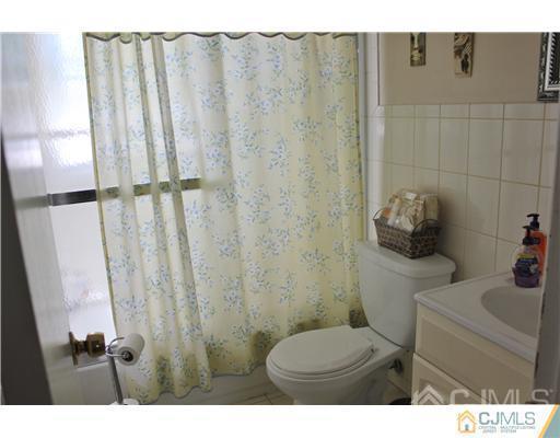 896 Inman Avenue Edison, NJ 08820 - Photo 11 of 14 a bathroom with a toilet and a sink