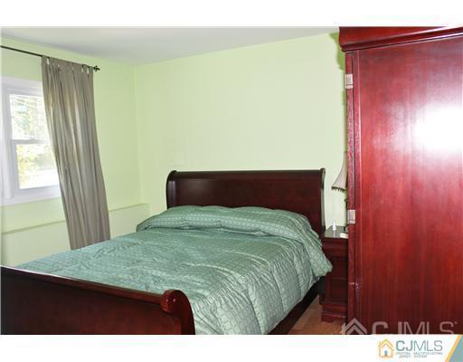 896 Inman Avenue Edison, NJ 08820 - Photo 12 of 14 a bedroom with a bed and a dresser