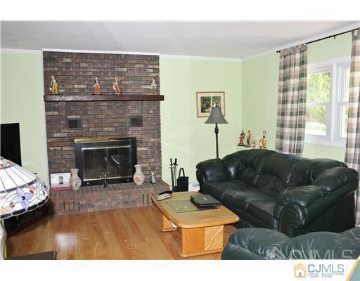 896 Inman Avenue Edison, NJ 08820 - Photo 7 of 14 a living room with furniture and a fireplace