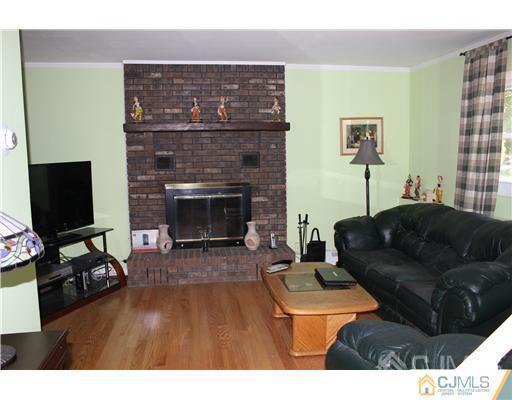 896 Inman Avenue Edison, NJ 08820 - Photo 8 of 14 a living room with furniture and a fireplace