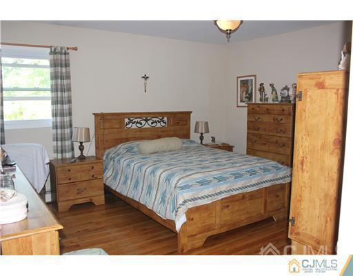 896 Inman Avenue Edison, NJ 08820 - Photo 9 of 14 a bedroom with a bed and a dresser