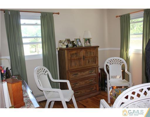 896 Inman Avenue Edison, NJ 08820 - Photo 10 of 14 a living room with furniture and wooden floor