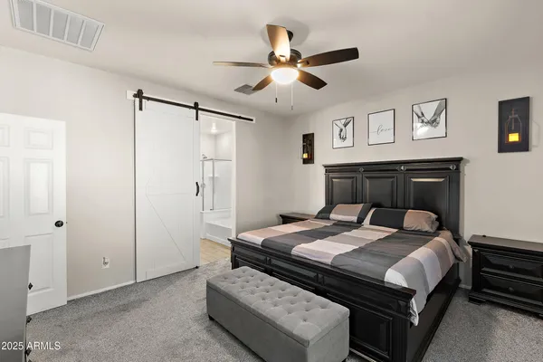 a bedroom with a bed and a chandelier