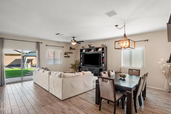 a living room with furniture a wooden floor and a flat screen tv