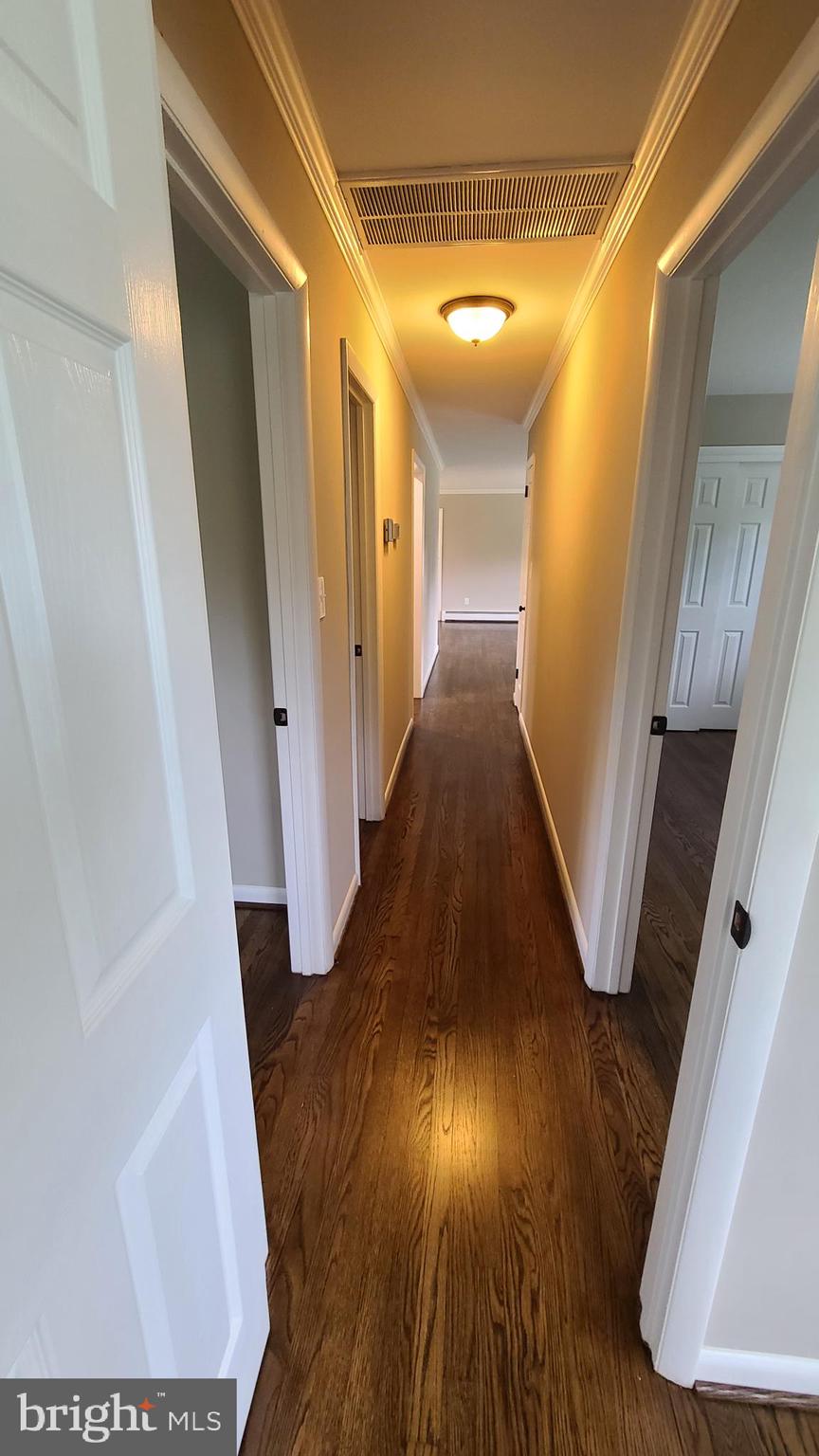 7 Cedar Drive Sterling, VA 20164 - Photo 14 of 40 a view of a hallway with wooden floor
