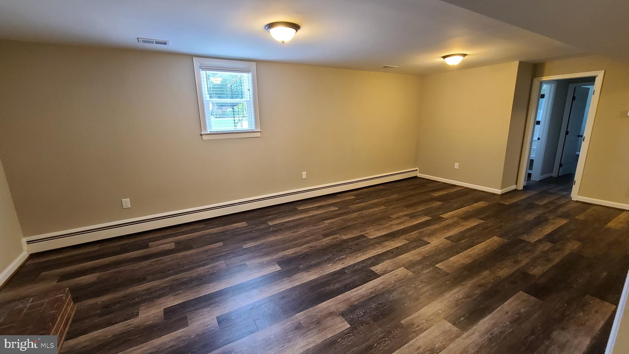 7 Cedar Drive Sterling, VA 20164 - Photo 20 of 40 a view of an empty room with wooden floor and a window