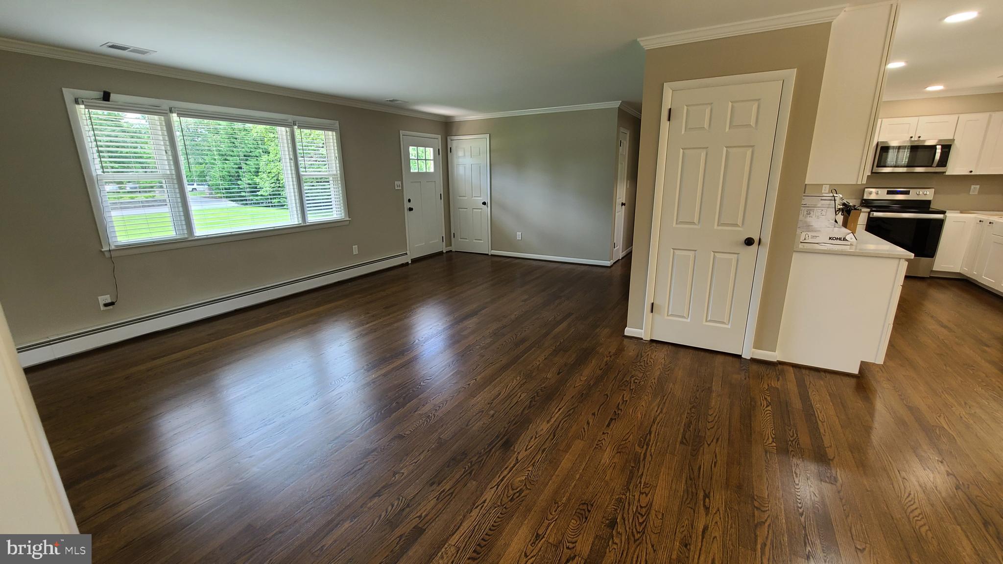 7 Cedar Drive Sterling, VA 20164 - Photo 2 of 40 an empty room with wooden floor and windows