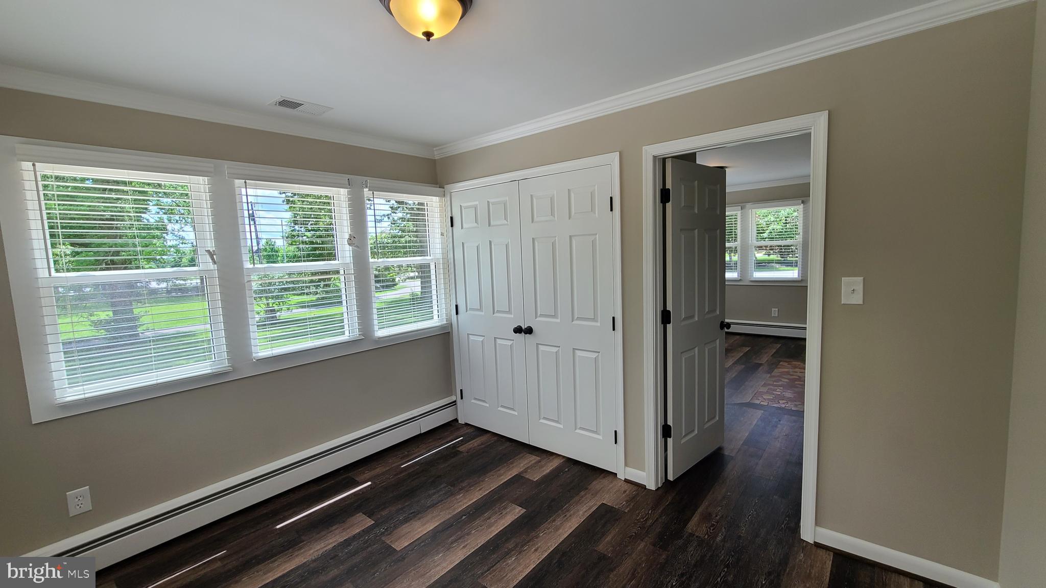7 Cedar Drive Sterling, VA 20164 - Photo 3 of 40 a view of an empty room with wooden floor and a window
