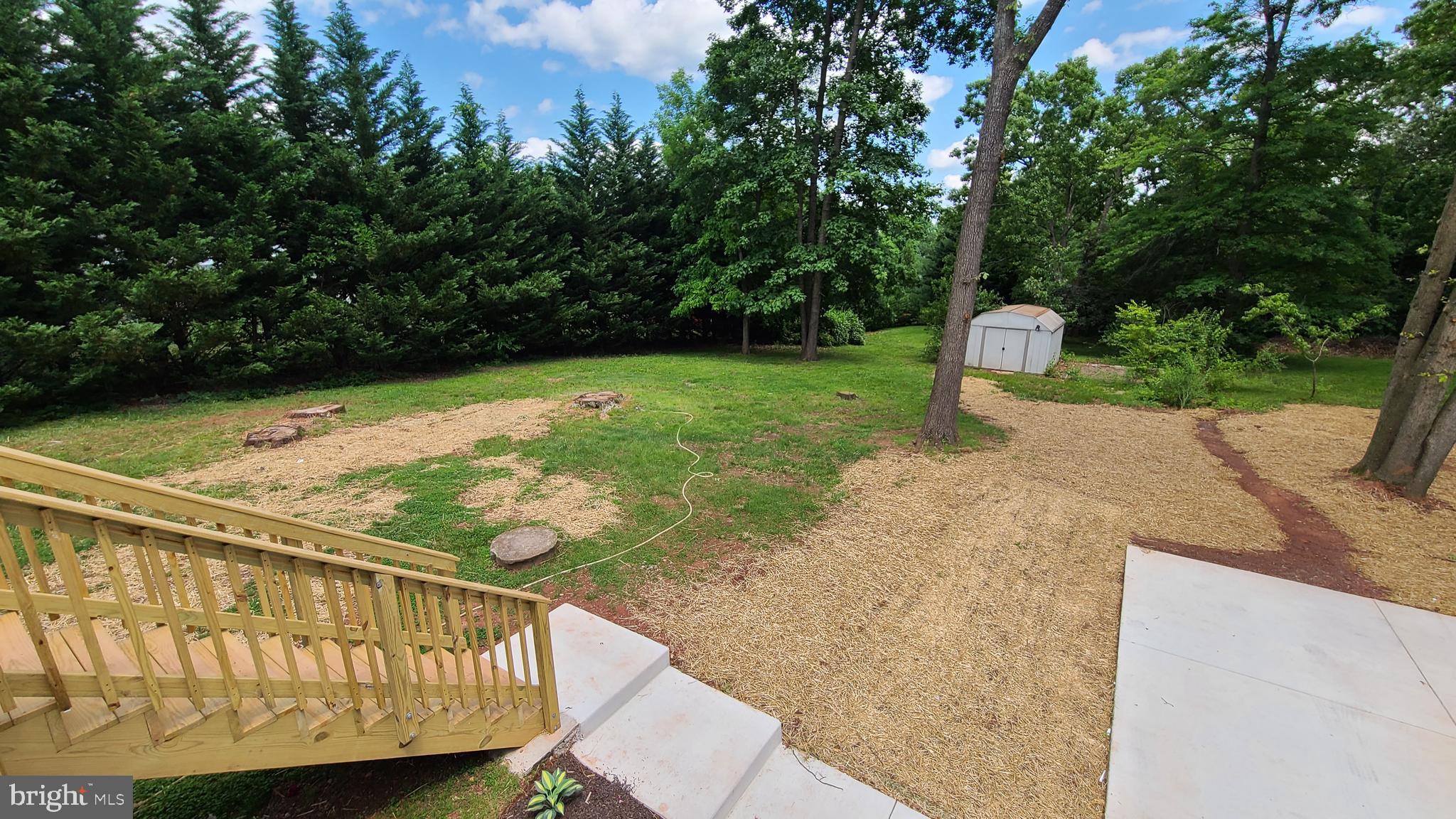 7 Cedar Drive Sterling, VA 20164 - Photo 34 of 40 a view of a wooden deck with two chairs and a table