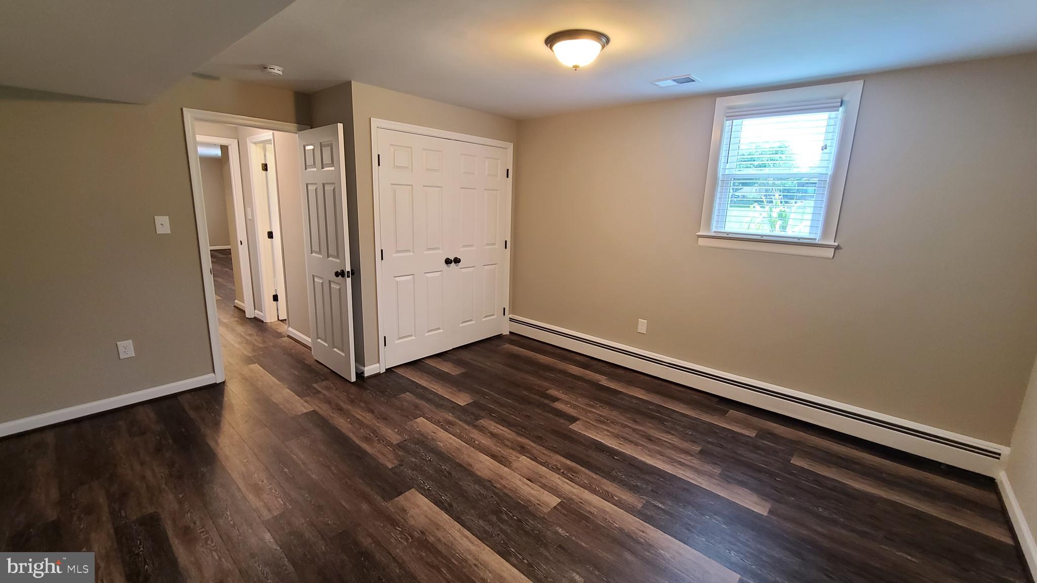 7 Cedar Drive Sterling, VA 20164 - Photo 8 of 40 a view of an empty room with wooden floor and a window