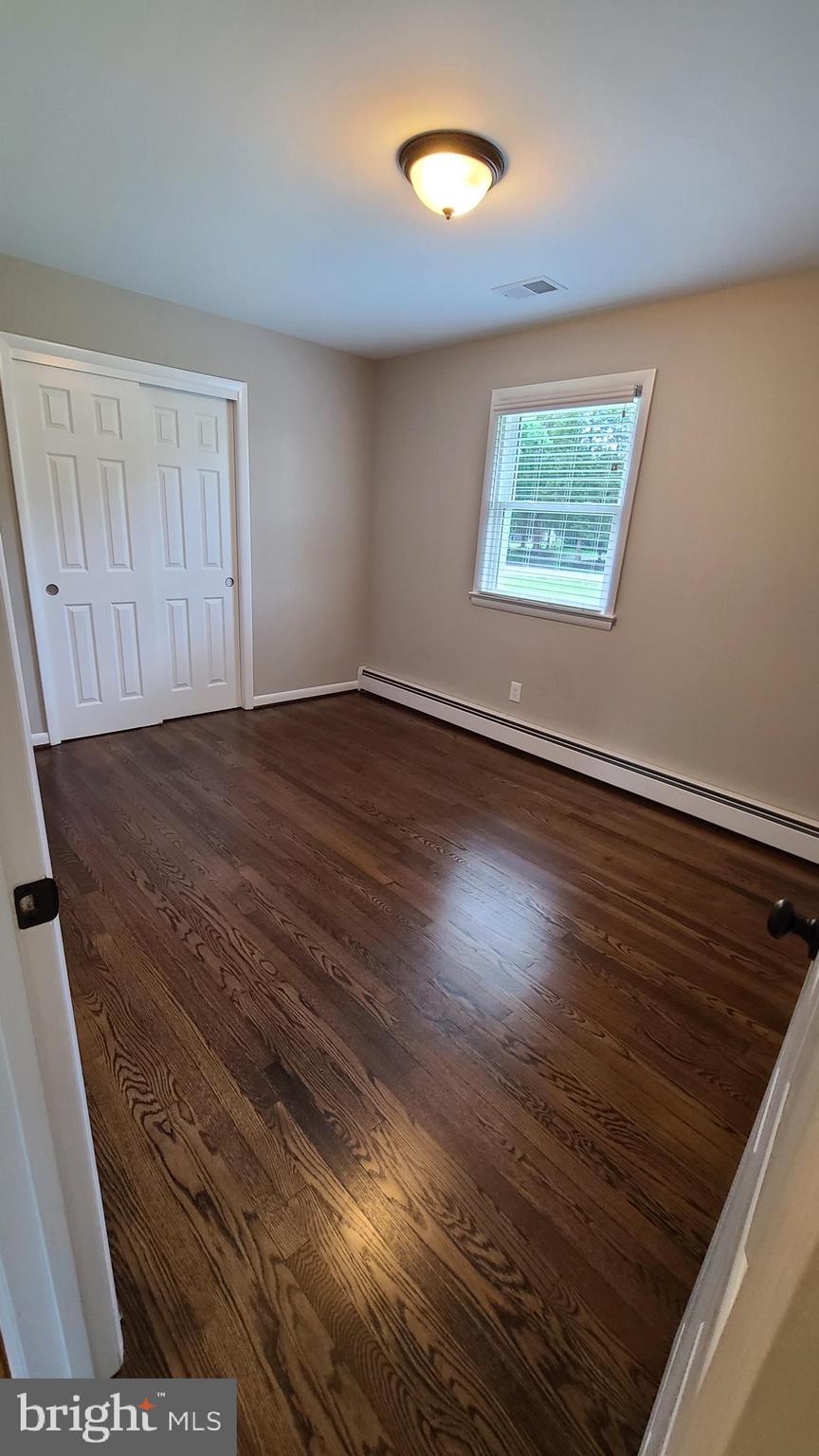7 Cedar Drive Sterling, VA 20164 - Photo 9 of 40 an empty room with wooden floor and windows