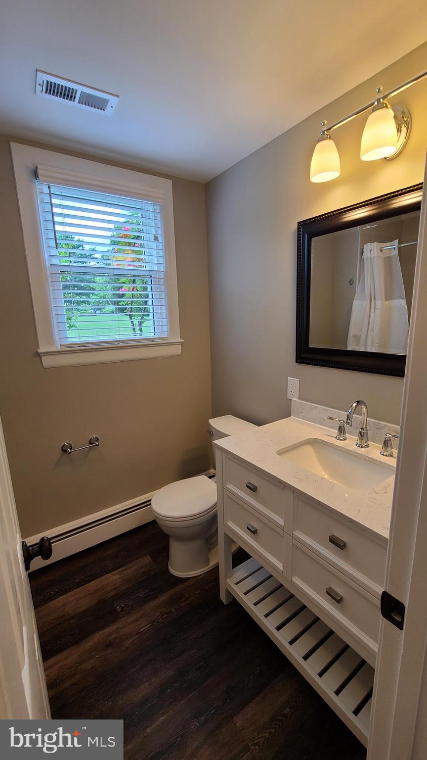 7 Cedar Drive Sterling, VA 20164 - Photo 10 of 40 a bathroom with a sink a toilet and mirror