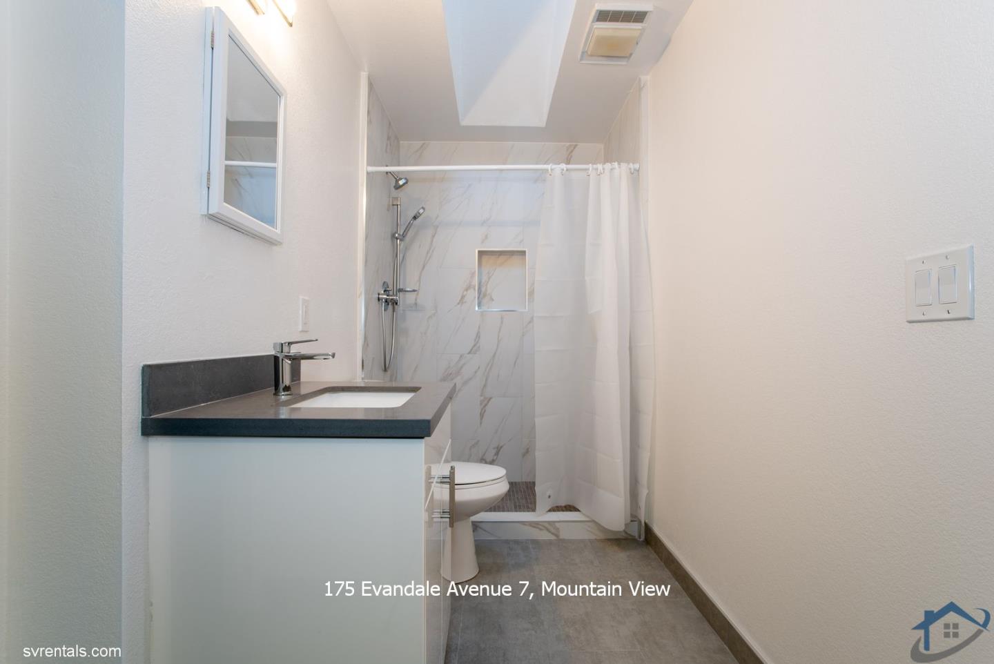 175 Evandale Avenue, Unit 7 Mountain View, CA 94043 - Photo 14 of 20 a bathroom with a granite countertop sink a toilet and a mirror