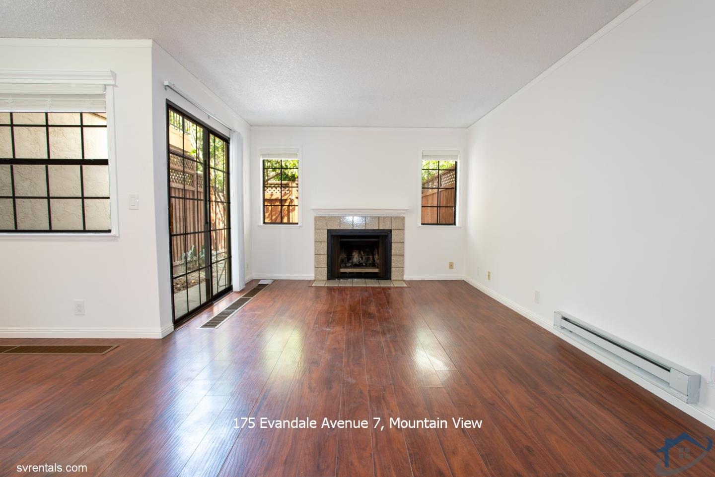 175 Evandale Avenue, Unit 7 Mountain View, CA 94043 - Photo 7 of 20 an empty room with wooden floor fireplace and windows