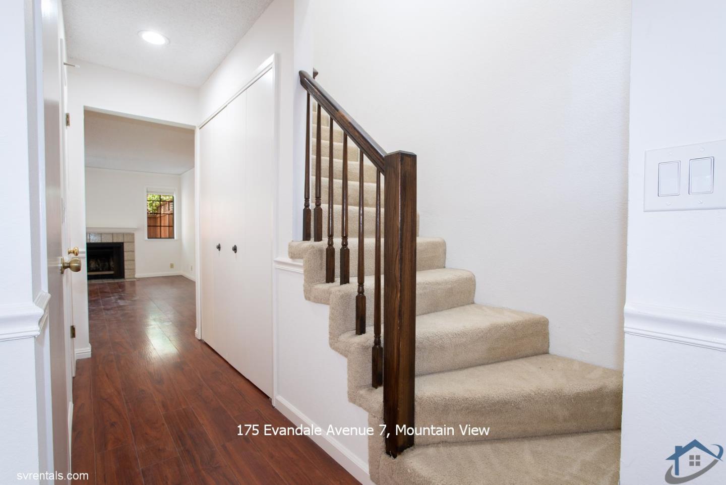 175 Evandale Avenue, Unit 7 Mountain View, CA 94043 - Photo 9 of 20 a hallway with couches and a potted plant with wooden floor