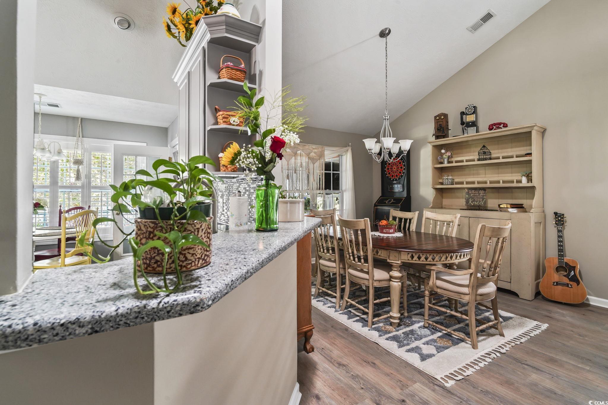 4105 Eva Bay Drive Murrells Inlet, SC 29576 - Photo 13 of 40 Dining room featuring light wood-style flooring, vaulted ceiling, and a chandelier