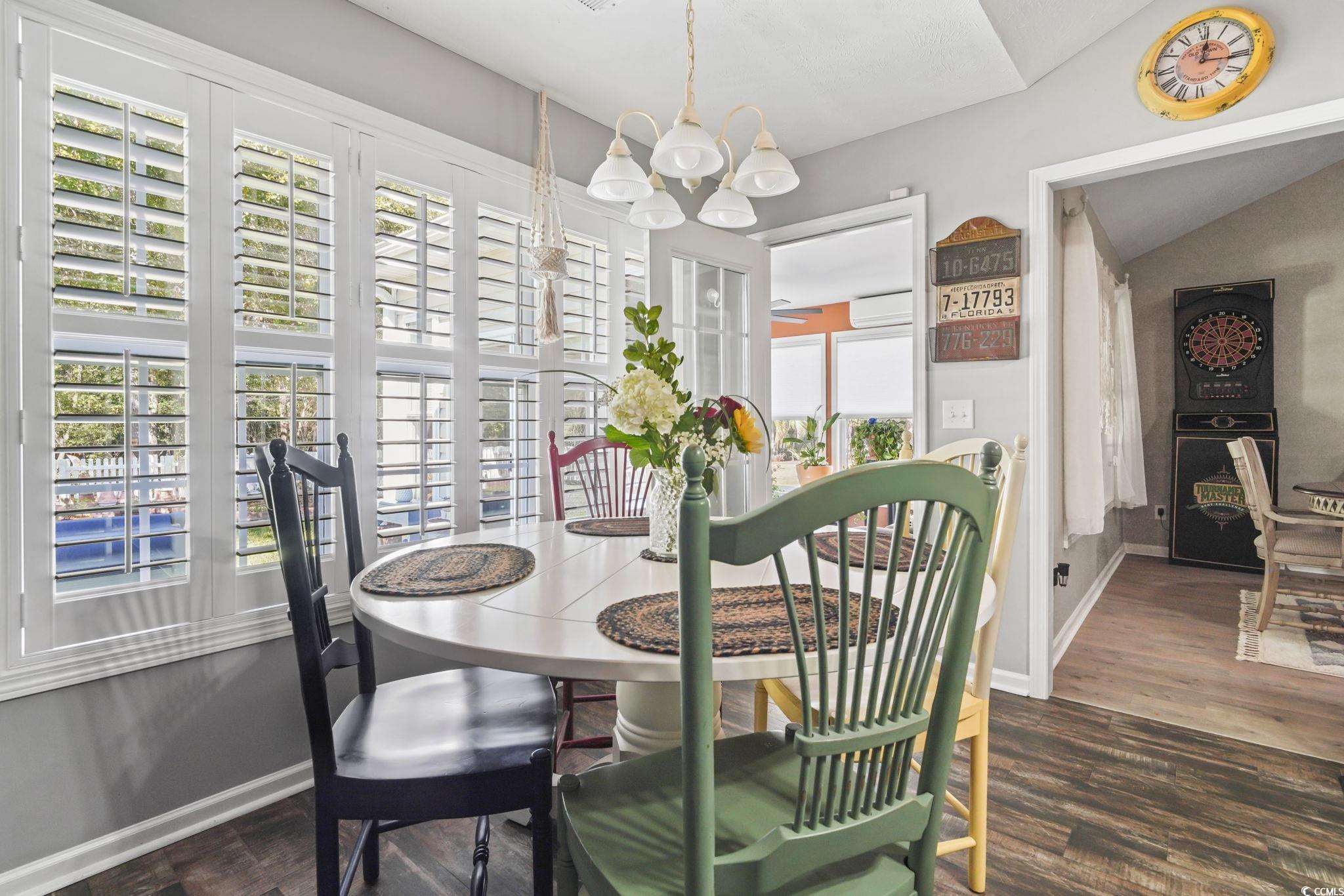 4105 Eva Bay Drive Murrells Inlet, SC 29576 - Photo 17 of 40 Dining area featuring vaulted ceiling, dark wood finished floors, and a chandelier