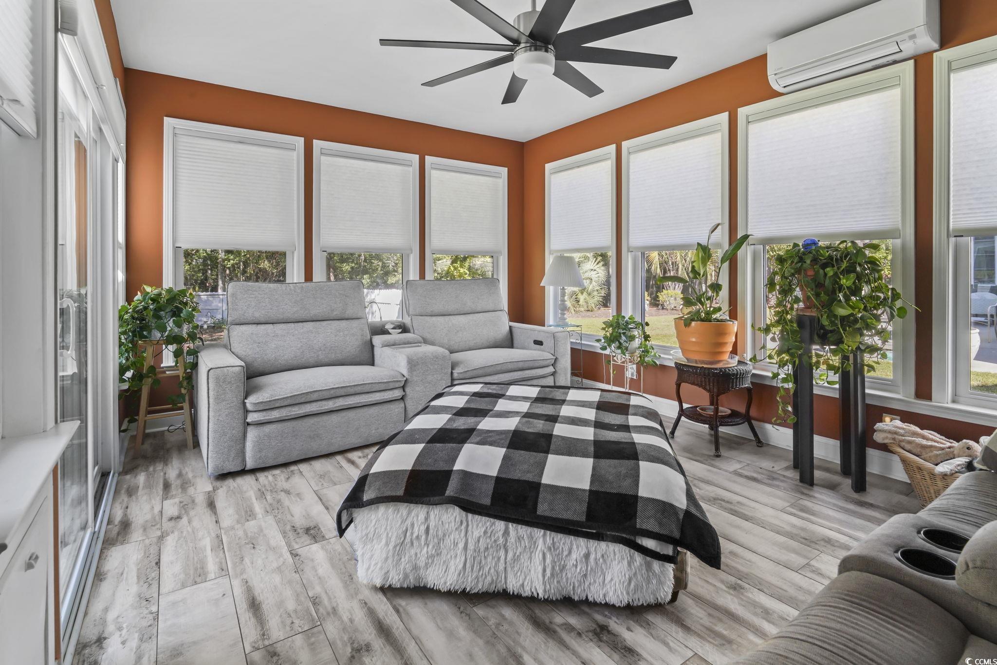 4105 Eva Bay Drive Murrells Inlet, SC 29576 - Photo 18 of 40 Sunroom / solarium featuring a wall mounted air conditioner and wood finished floors