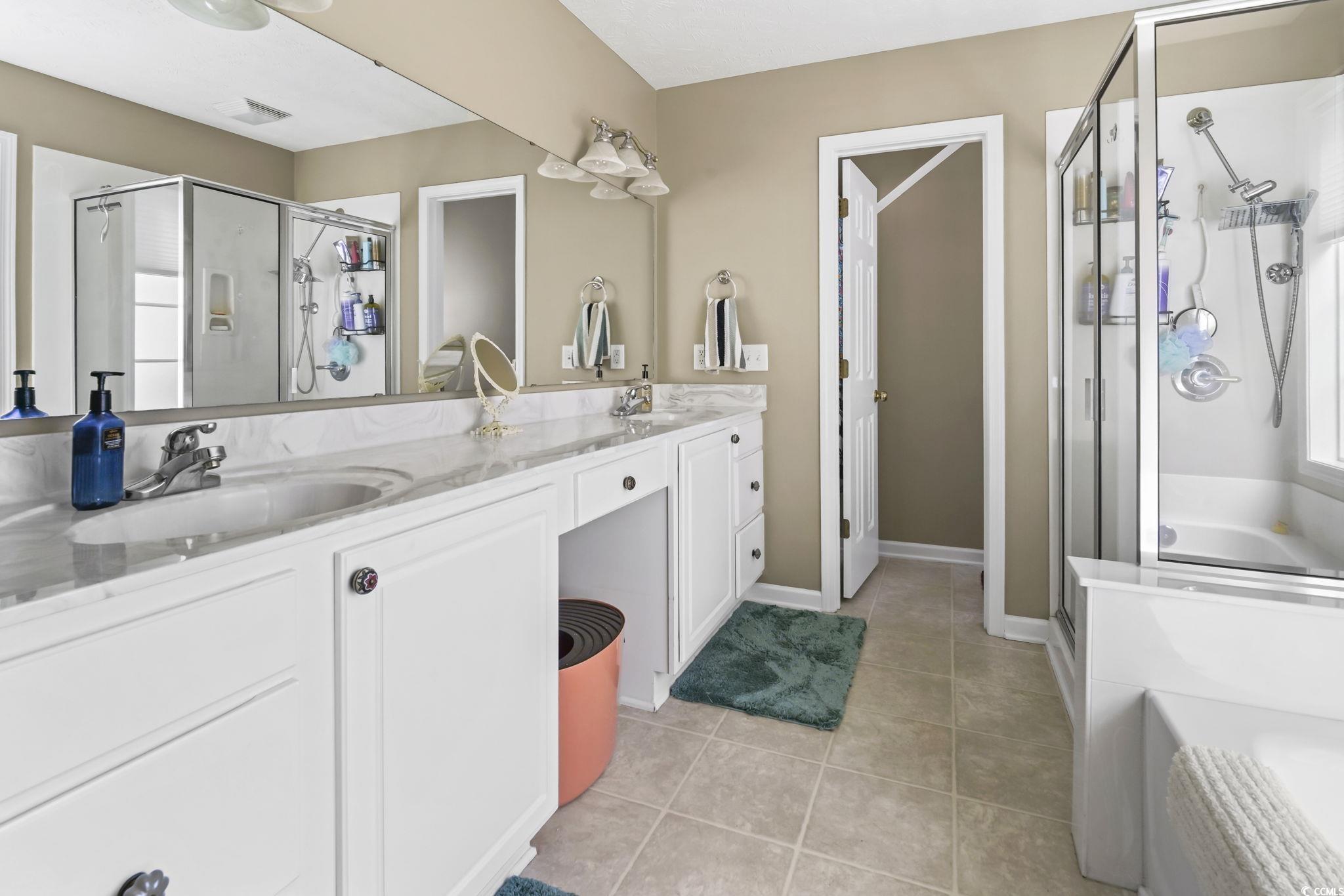 4105 Eva Bay Drive Murrells Inlet, SC 29576 - Photo 26 of 40 Full bathroom featuring a bath, a shower stall, double vanity, and light tile patterned flooring