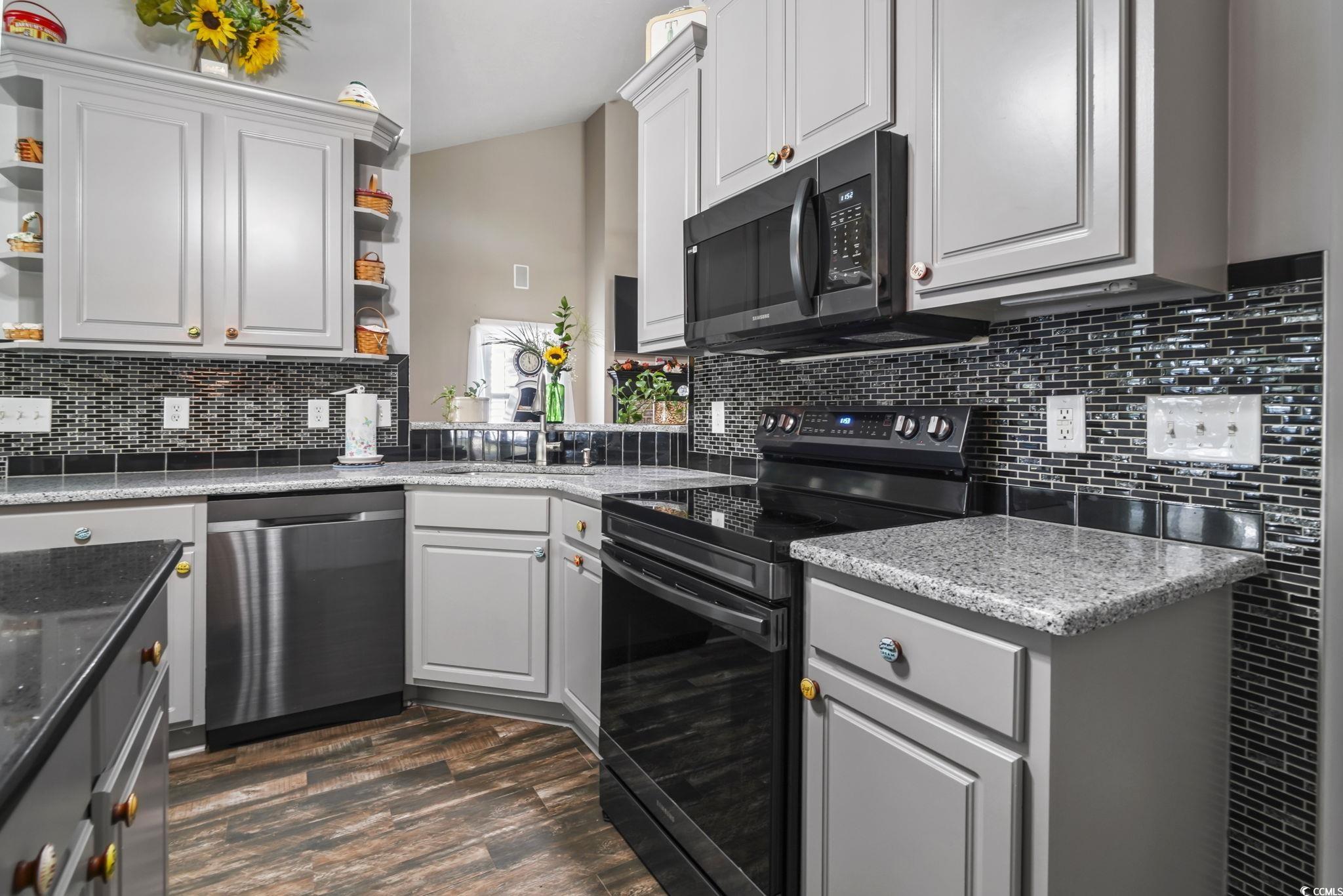 4105 Eva Bay Drive Murrells Inlet, SC 29576 - Photo 3 of 40 Kitchen featuring open shelves, black appliances, gray cabinetry, backsplash, and light stone countertops