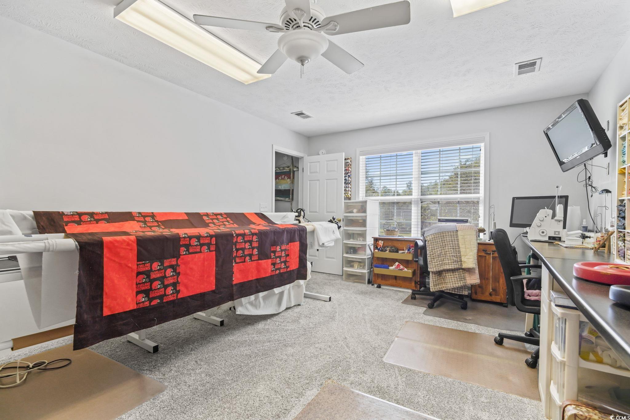 4105 Eva Bay Drive Murrells Inlet, SC 29576 - Photo 31 of 40 Bedroom featuring an office area, light carpet, a textured ceiling, and a ceiling fan