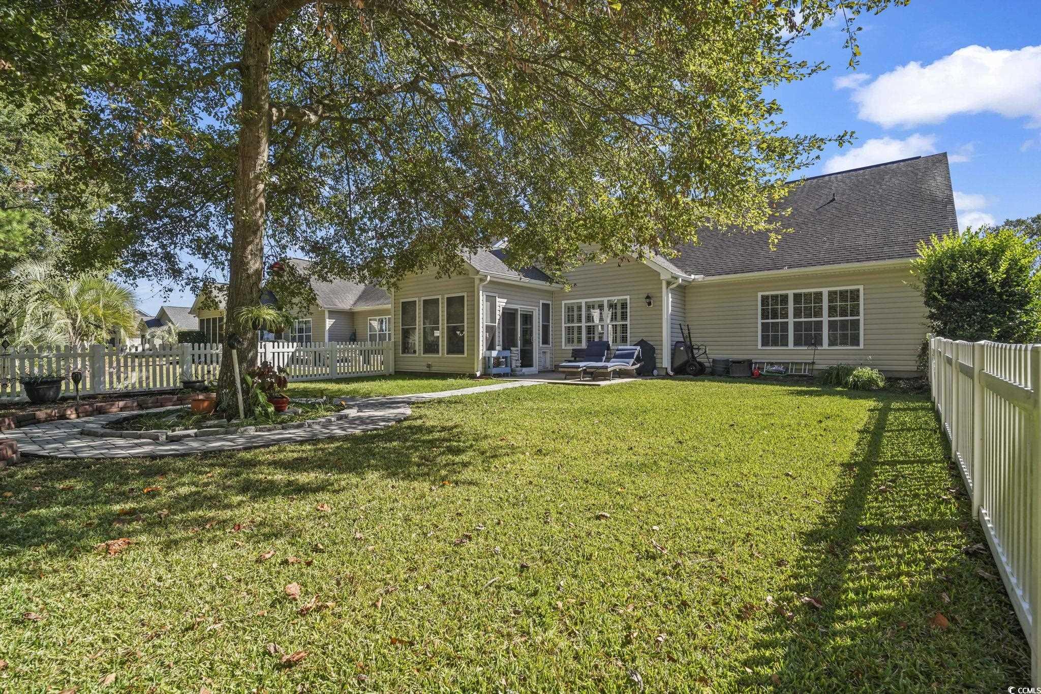 4105 Eva Bay Drive Murrells Inlet, SC 29576 - Photo 33 of 40 Back of house with a fenced backyard, a patio, a sunroom, and a shingled roof