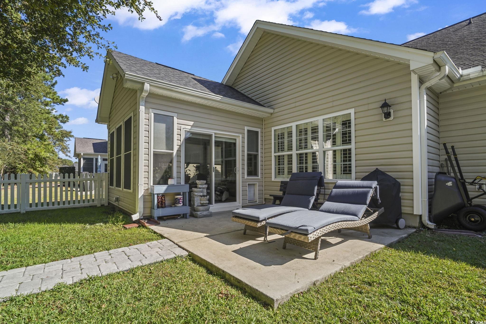 4105 Eva Bay Drive Murrells Inlet, SC 29576 - Photo 34 of 40 Rear view of house with a shingled roof and a patio