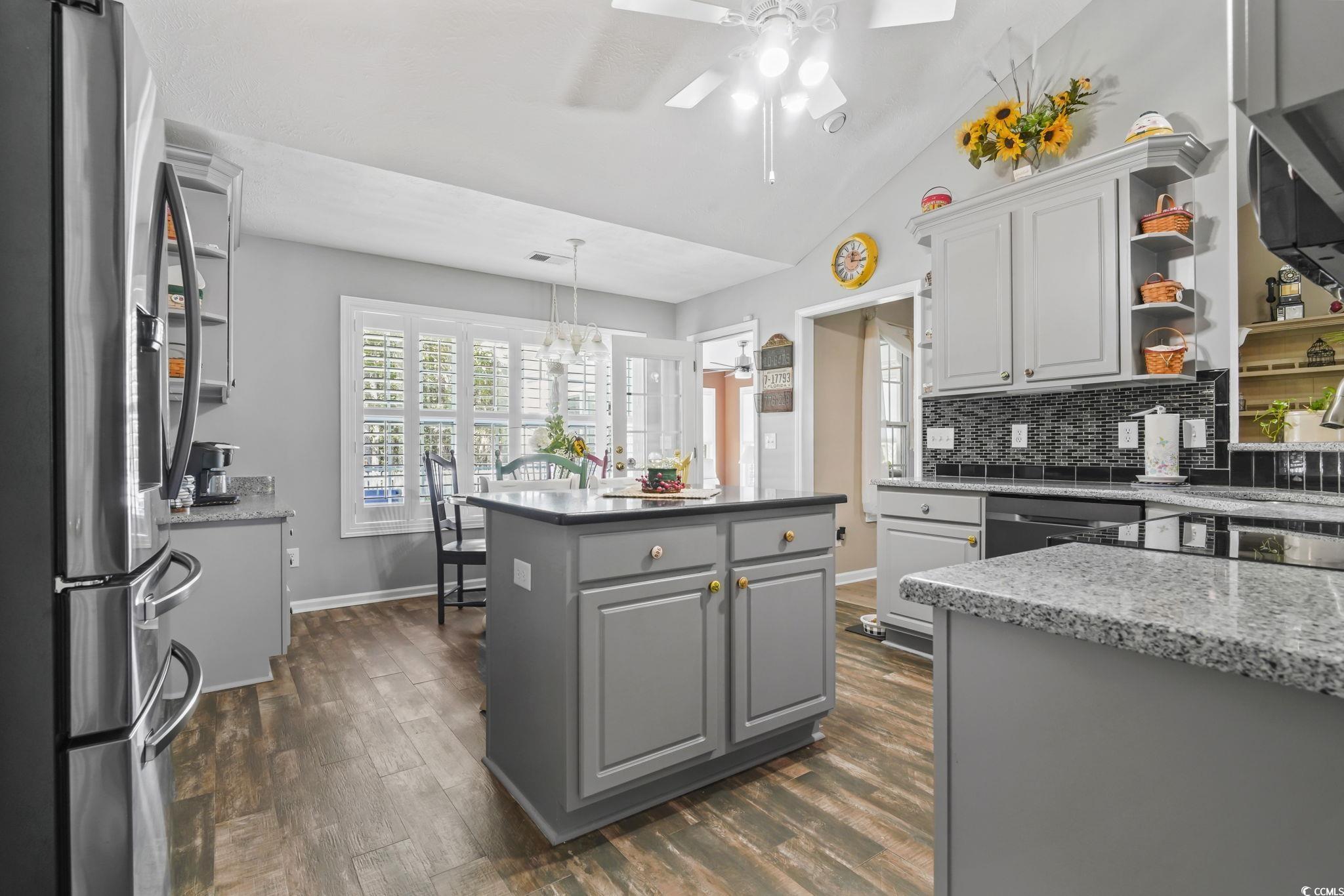 4105 Eva Bay Drive Murrells Inlet, SC 29576 - Photo 5 of 40 Kitchen featuring gray cabinets, open shelves, stainless steel appliances, backsplash, and vaulted ceiling