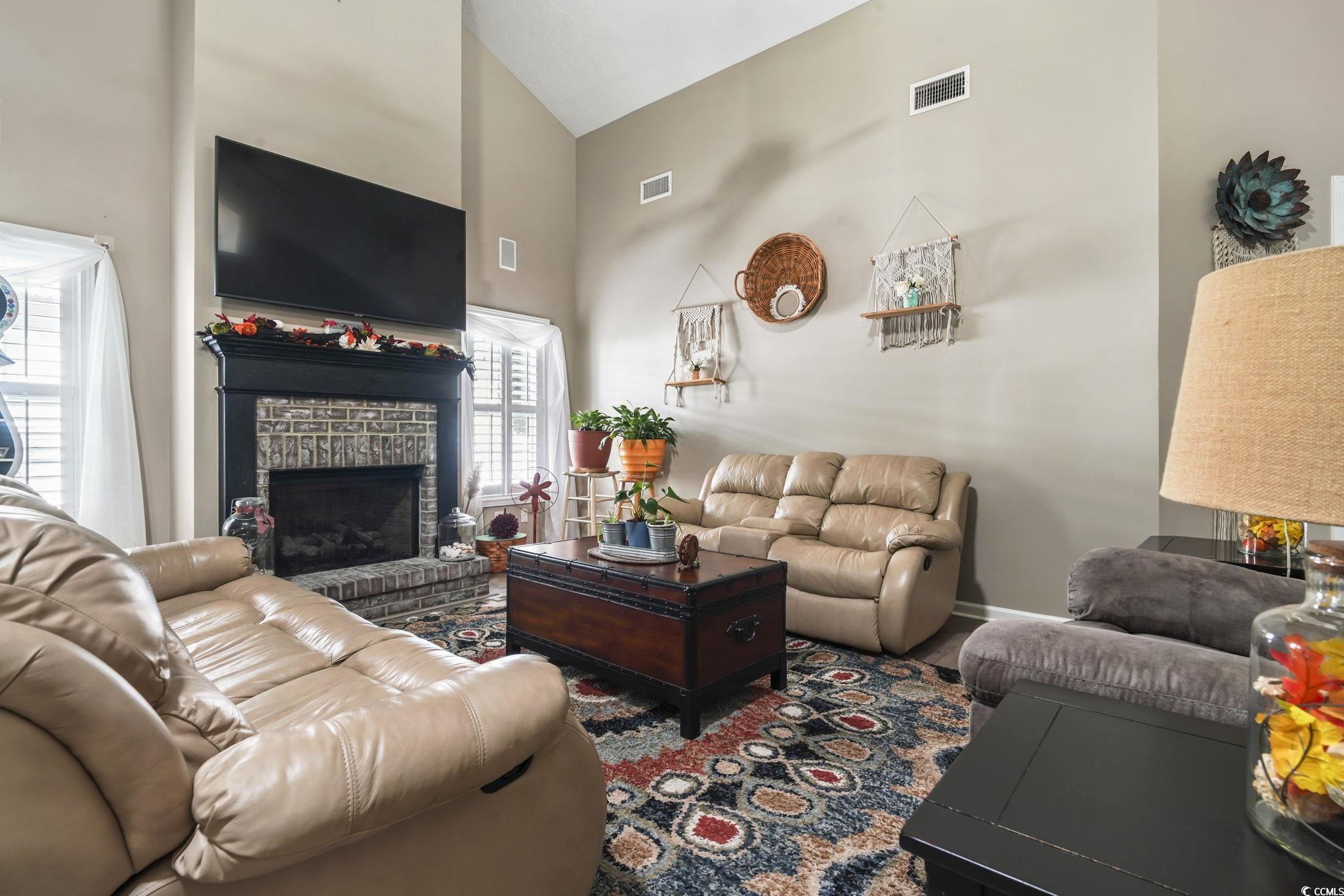 4105 Eva Bay Drive Murrells Inlet, SC 29576 - Photo 10 of 40 Living area with high vaulted ceiling and a brick fireplace