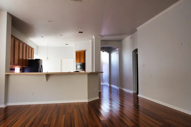 a living room with hard wood floors and a wooden floor