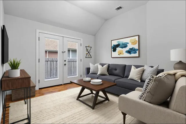 a living room with furniture and wooden floor