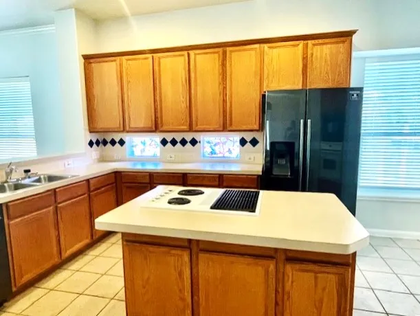 a kitchen with a sink a counter top space and stainless steel appliances