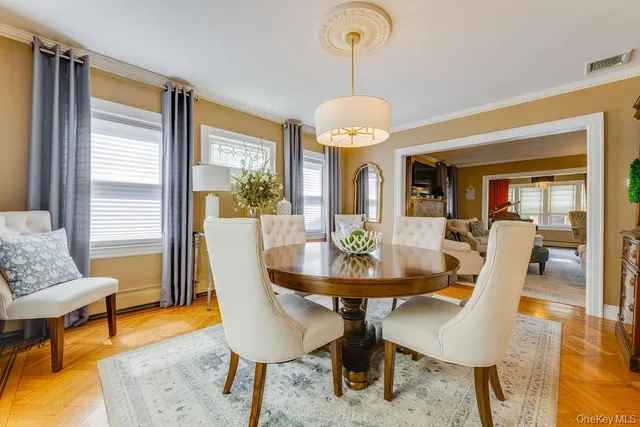 a view of a dining room with furniture window and wooden floor