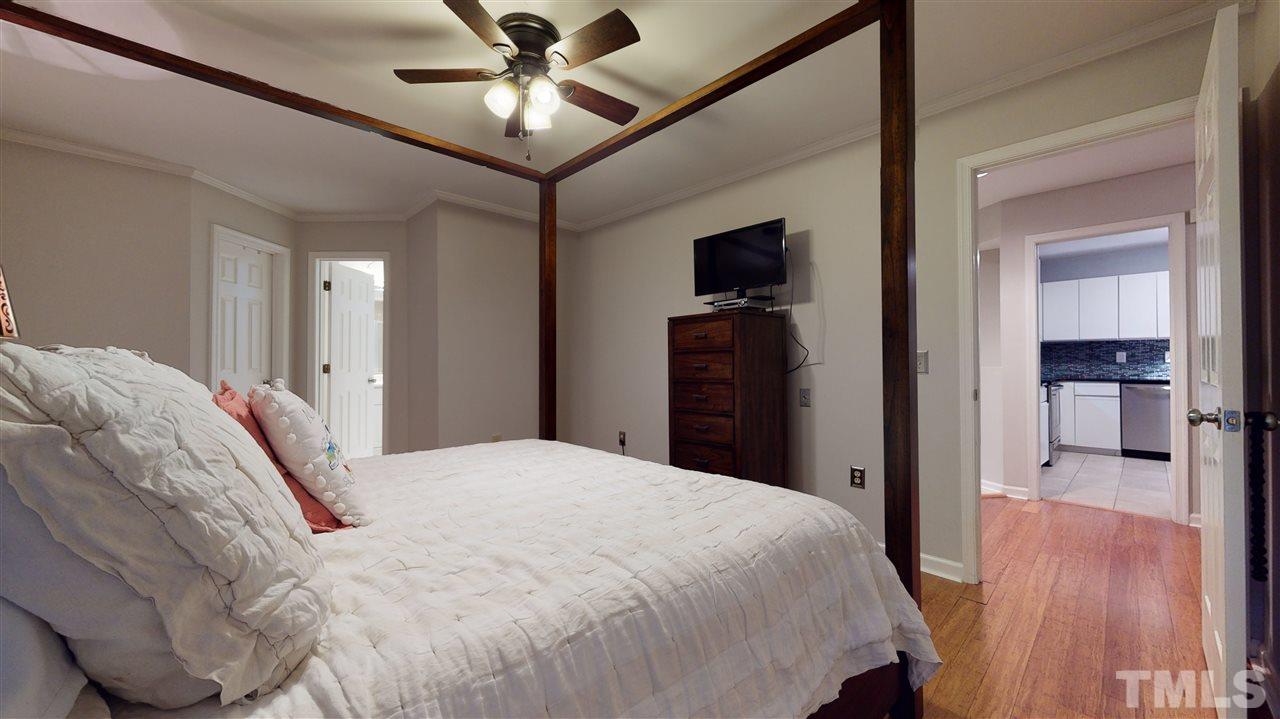 3827 Carnegie Lane Raleigh, NC 27612 - Photo 16 of 30 a bed room with a bed and a television