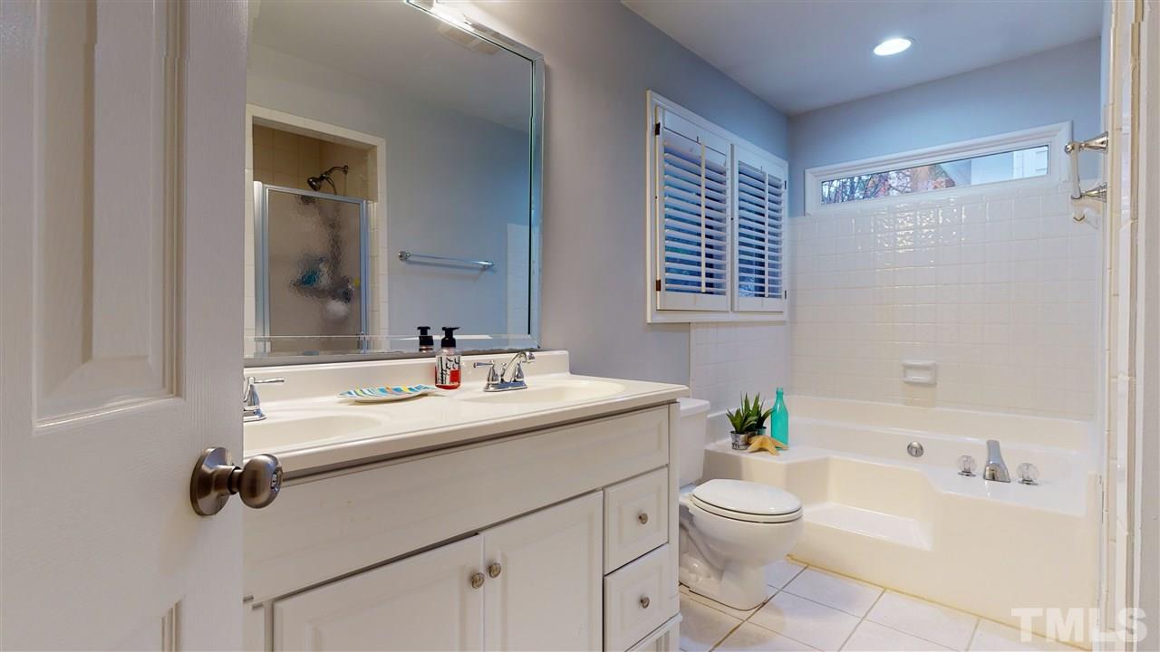 3827 Carnegie Lane Raleigh, NC 27612 - Photo 18 of 30 a bathroom with a sink toilet tub and vanity