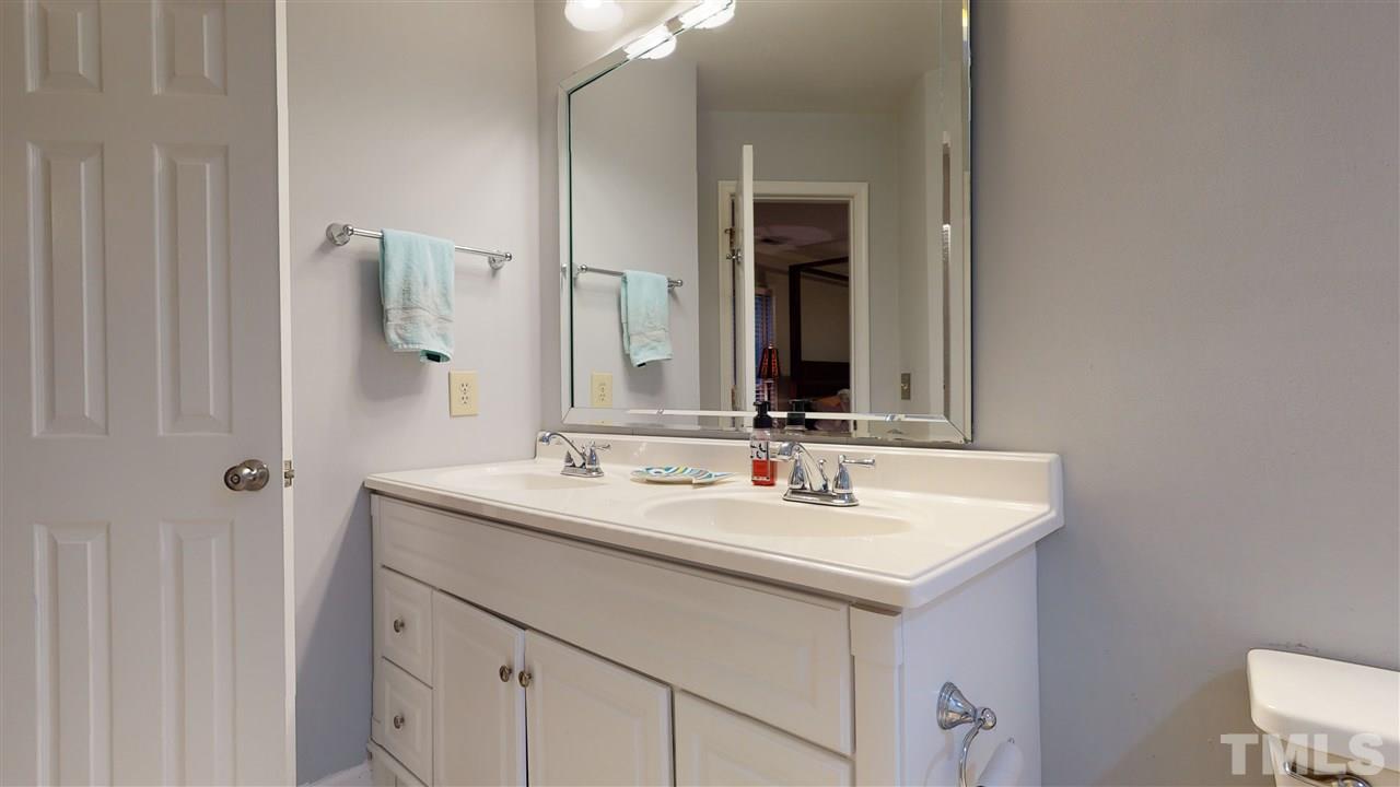 3827 Carnegie Lane Raleigh, NC 27612 - Photo 19 of 30 a bathroom with a sink and a mirror
