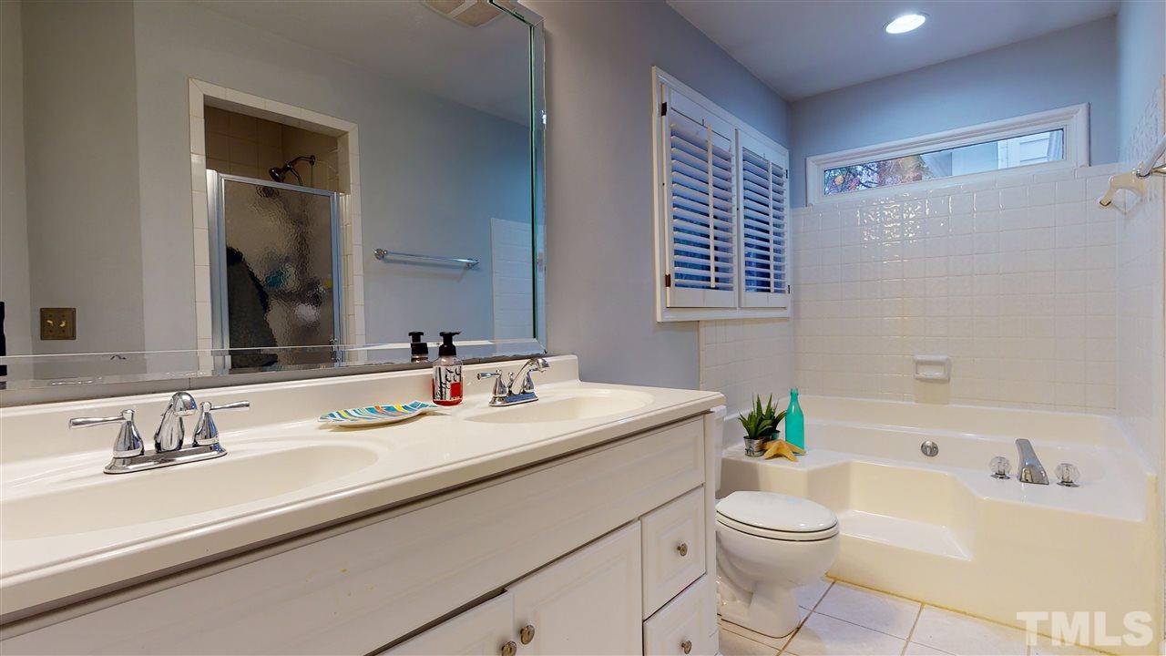 3827 Carnegie Lane Raleigh, NC 27612 - Photo 21 of 30 a bathroom with a granite countertop sink mirror vanity and toilet