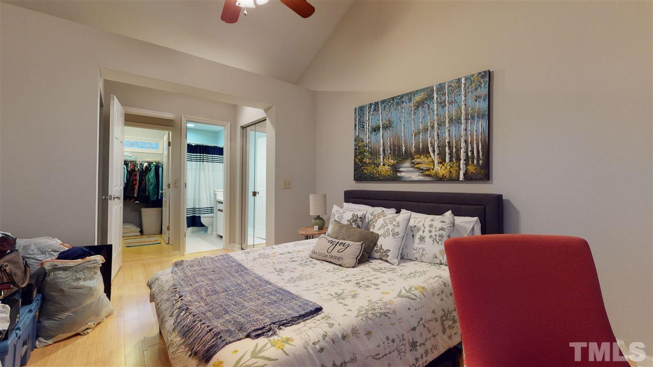 3827 Carnegie Lane Raleigh, NC 27612 - Photo 25 of 30 a bedroom with a bed and a painting on the wall