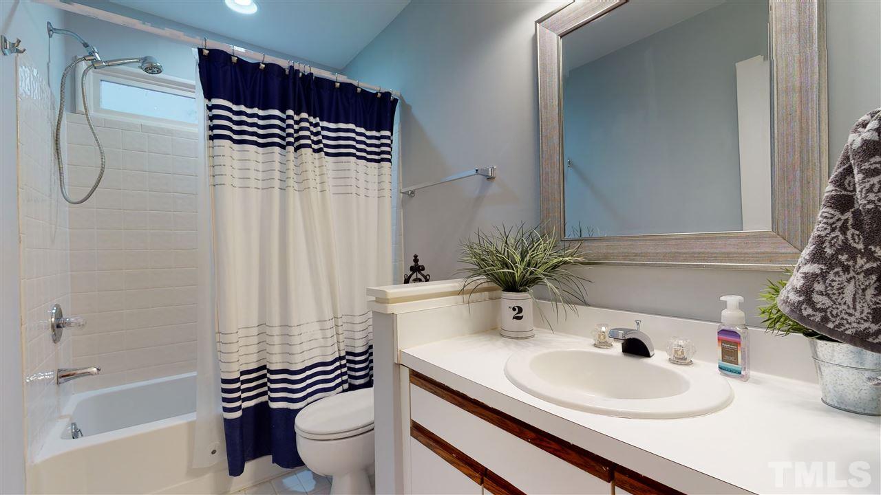3827 Carnegie Lane Raleigh, NC 27612 - Photo 26 of 30 a bathroom with a sink a toilet and a bathtub