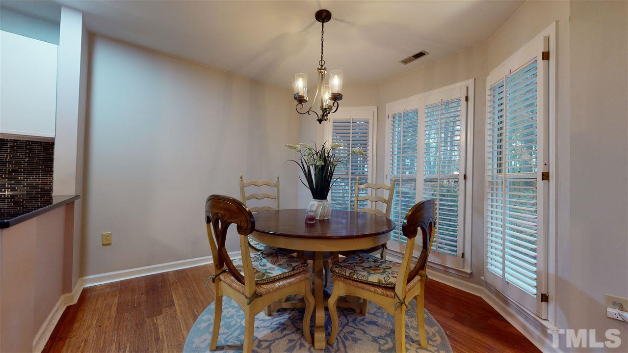 3827 Carnegie Lane Raleigh, NC 27612 - Photo 9 of 30 a dining room with furniture window and wooden floor
